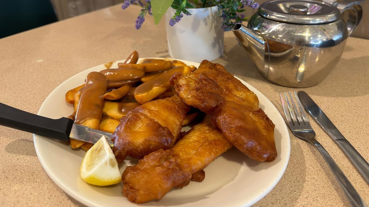 Plate of fish and chips served with lemon and dipping sauce at Green Gables Restaurant & Lounge