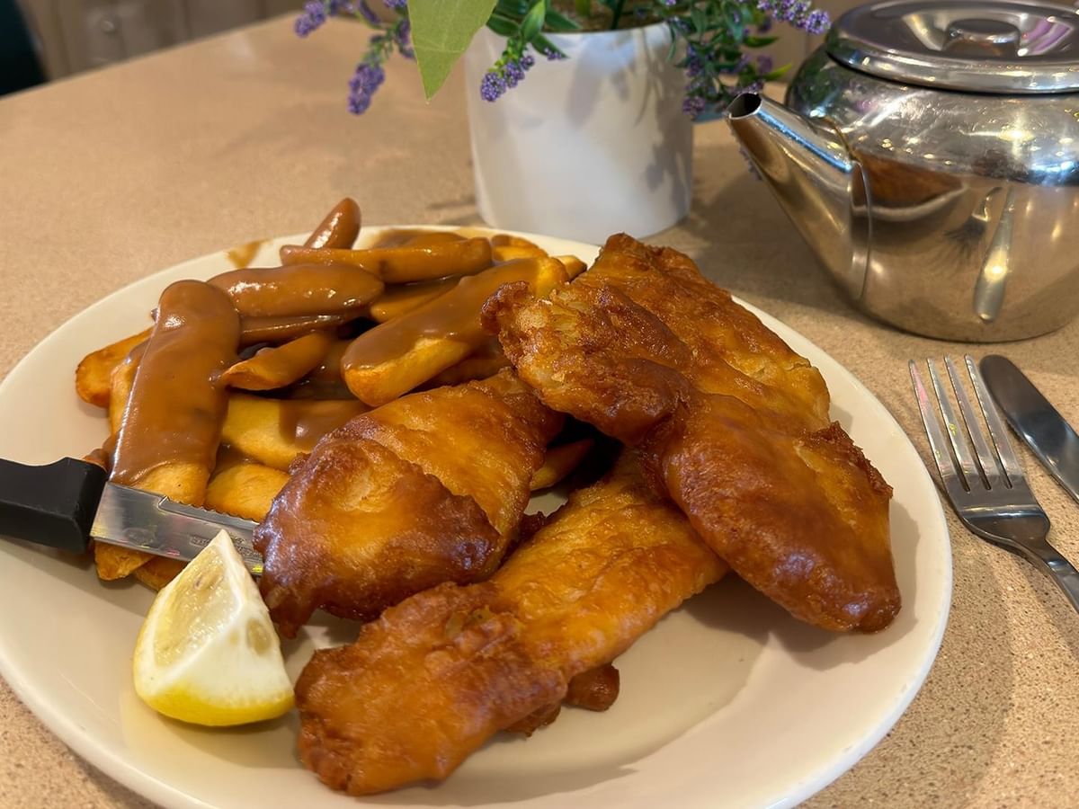 Fish and chips served with fries at Green Gables Restaurant & Lounge