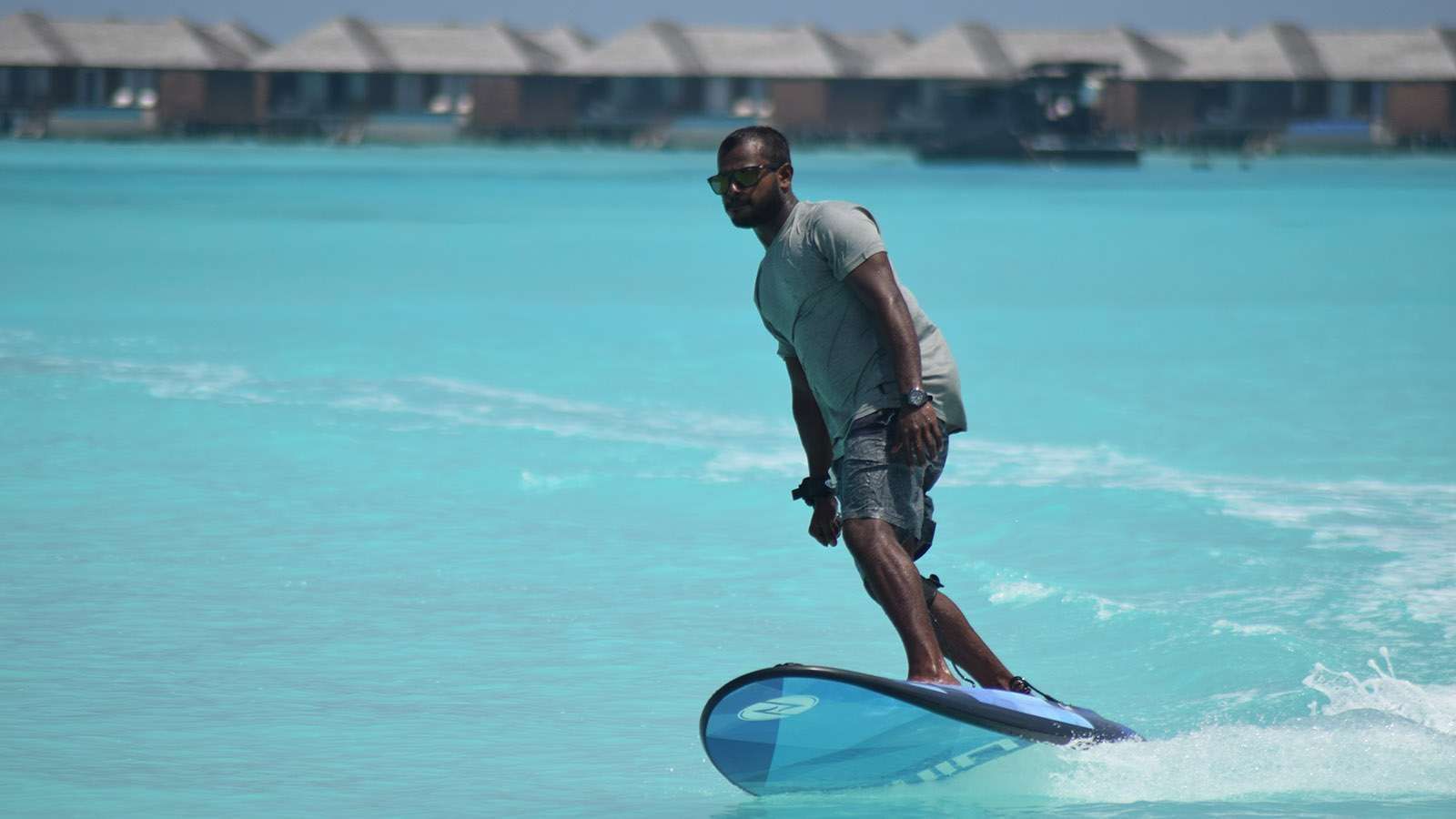 A surfer on E-surfing in the sea near The Signature Collection