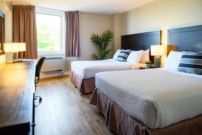 Workspace facing the beds in Spacious Suite Two Queen at Rodd Grand Yarmouth, offering cozy accommodation in Yarmouth