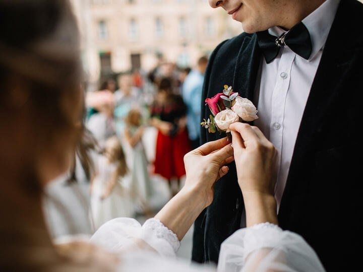 Girl pin flowers In Pocket Of Groom at The Explorean Kohunlich