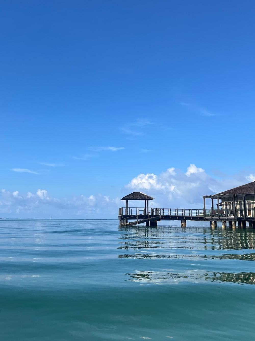 Overwater villa with a bridge entrance over calm water at Warwick Le Lagon - Vanuatu, Efate.