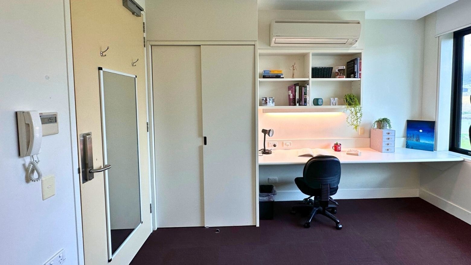 Compact room with desk, chair, and built-in shelves at La Trobe University - McFarlane's Hill Residences.