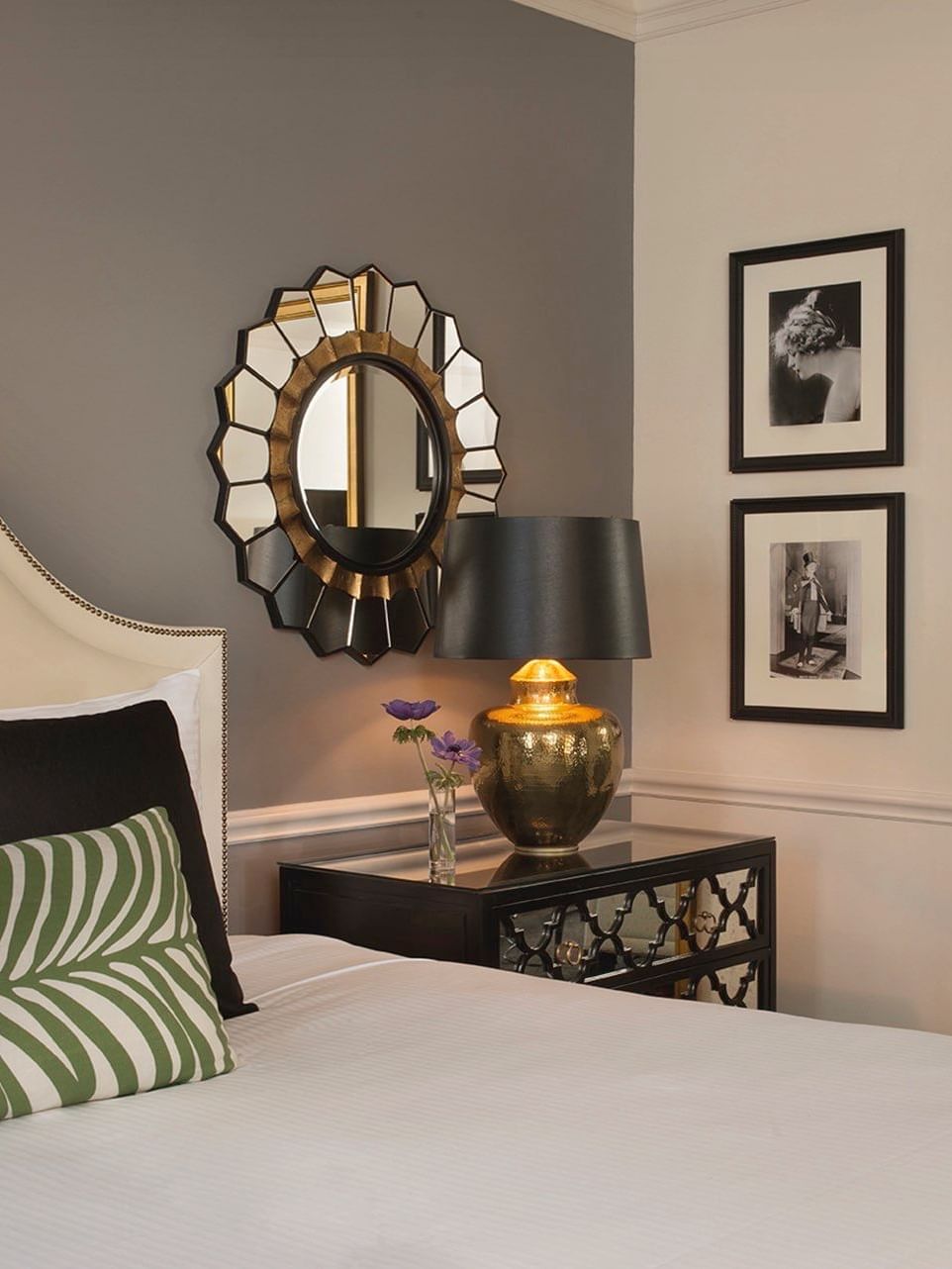 Bed with side table under patterned mirror in Marion Suite at Warwick New York