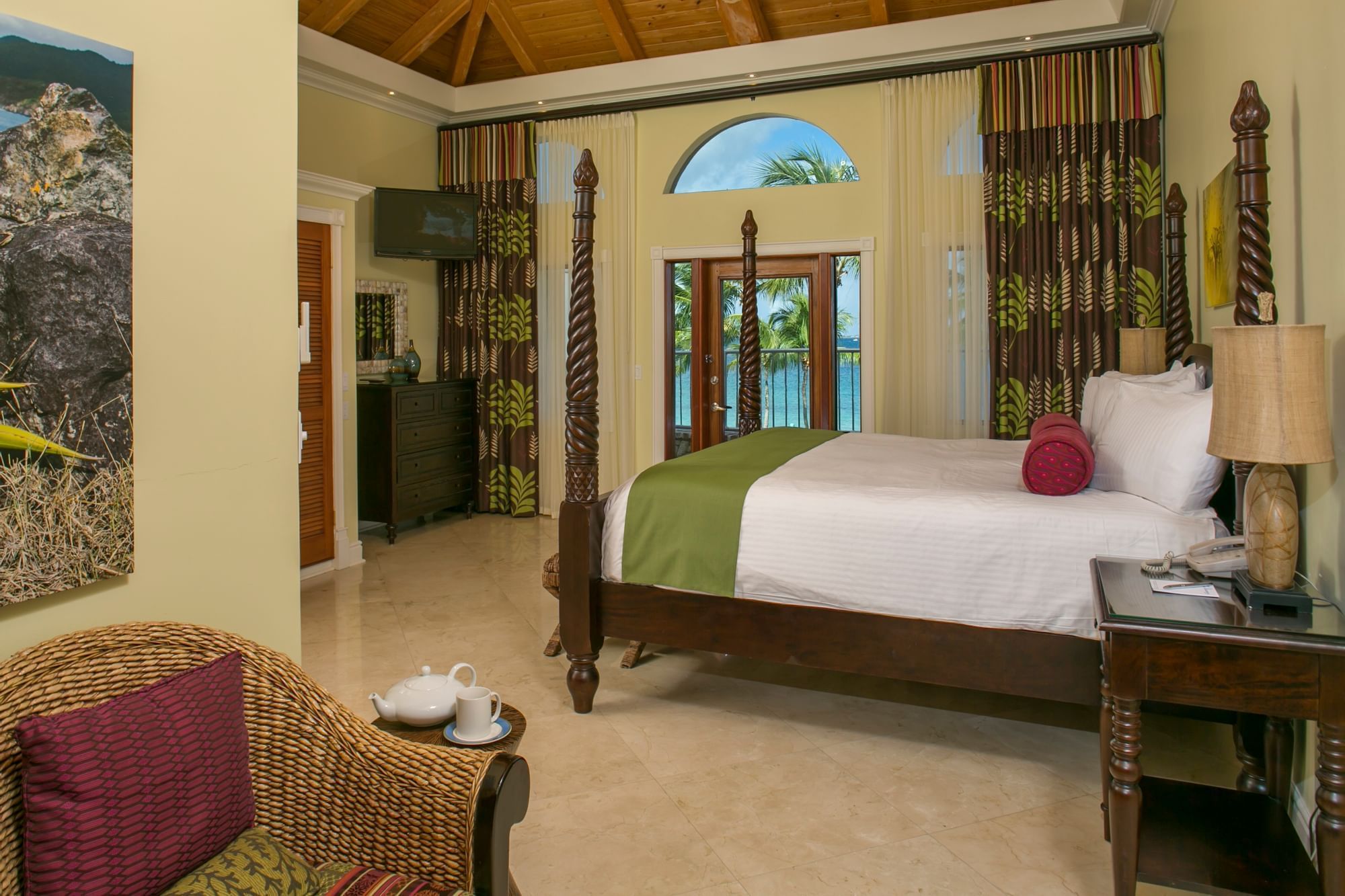 Comfy bed & lounge area in Ficus Suite at The Buccaneer Resort St. Croix