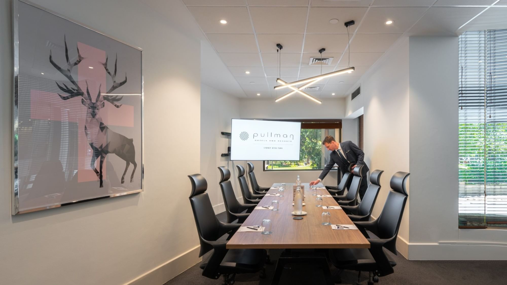 Boardroom set-up with TV in Frazer Room at Pullman Sydney Hyde Park