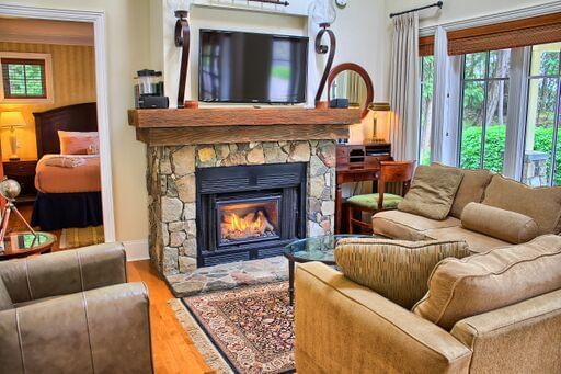 Living room with couch and fireplace at Poets Cove Resort & Spa