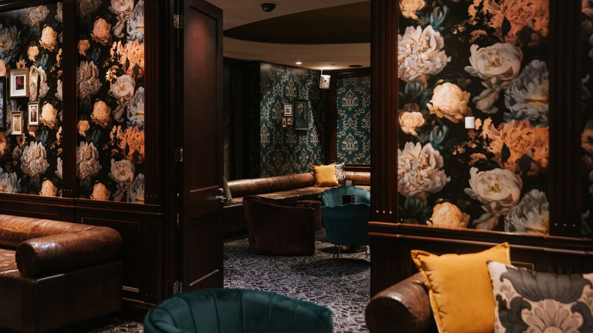 Interior of Minq Bar Lounge  with floral wallpaper & plush seating at Crown Hotels Perth