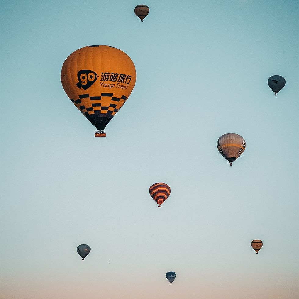 Hot air balloons floating in the clear sky near Falkensteiner Hotel Prague