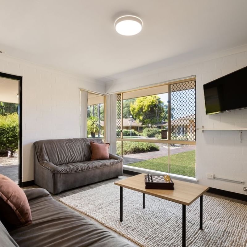 Cozy living room with two couches, a coffee table, and a TV at Vickery House.