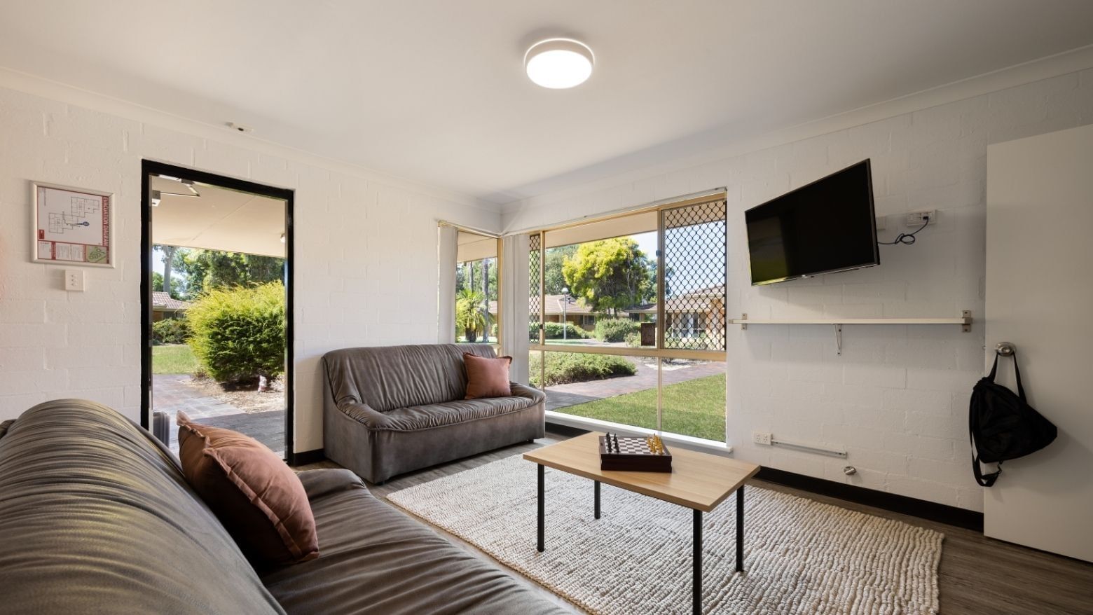 Cozy living room with two couches, a coffee table, and a TV at Vickery House.