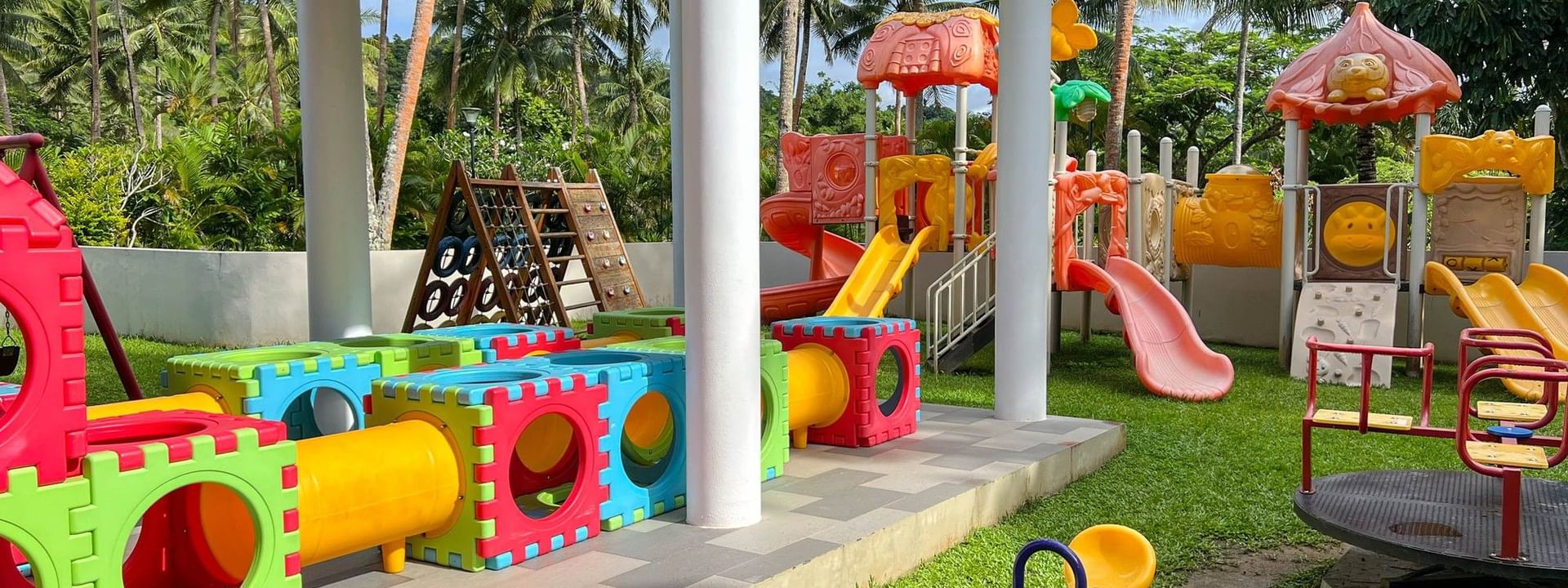 Colorful children's playground with slides, swings, and activity stations at The Naviti Resort in Korolevu.