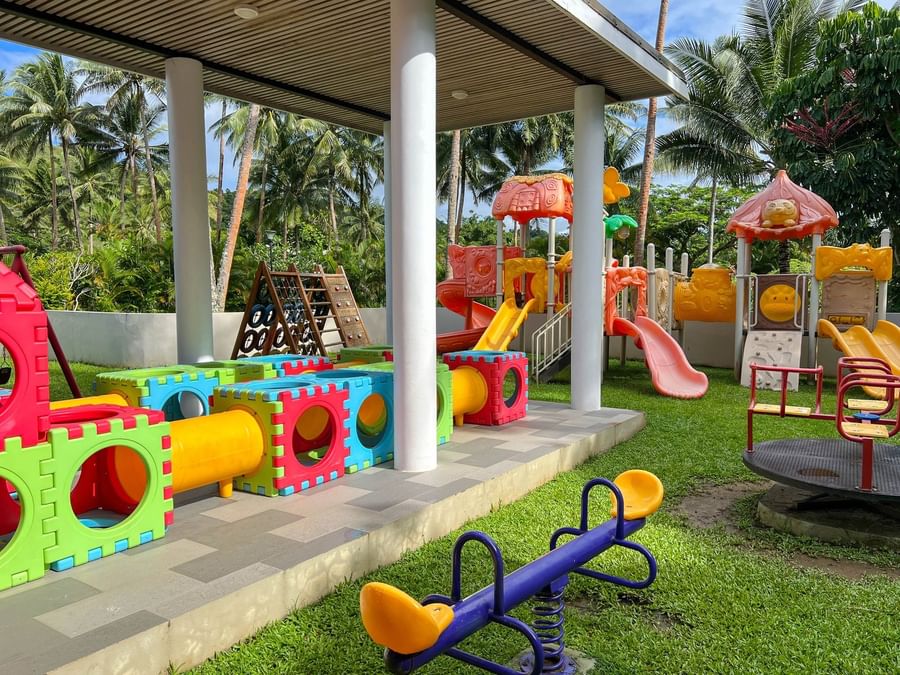 Colorful children's playground with slides, swings, and activity stations at The Naviti Resort in Korolevu.