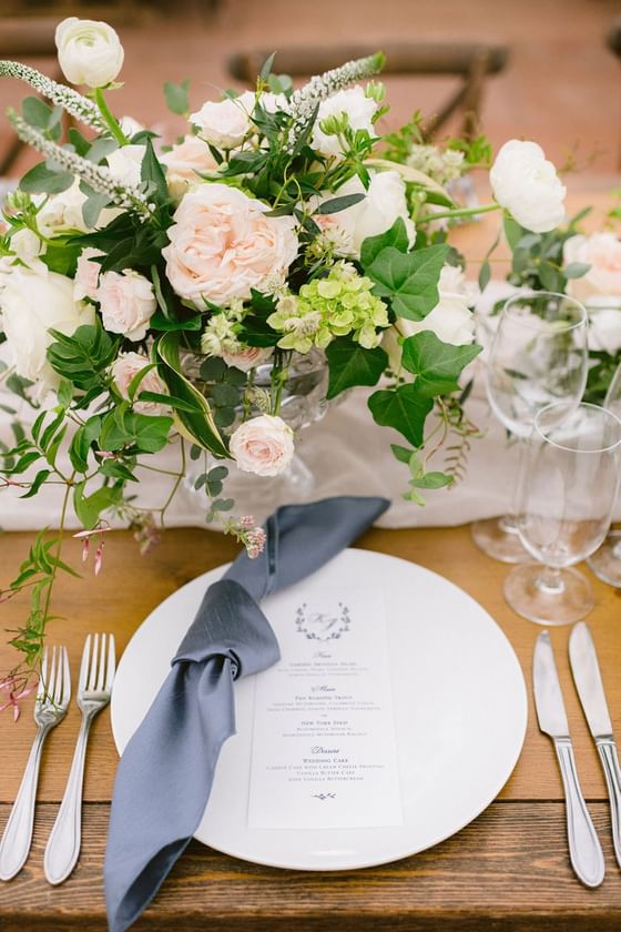 Fresh flowers, glassware & cutlery on a banquet table at The Clifton
