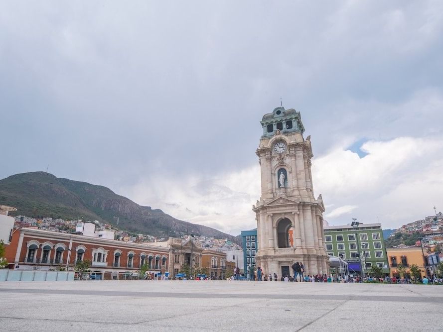 Historic Monumental Clock of Pachuca in a wide public square under a cloudy sky near Camino Real Pachuca