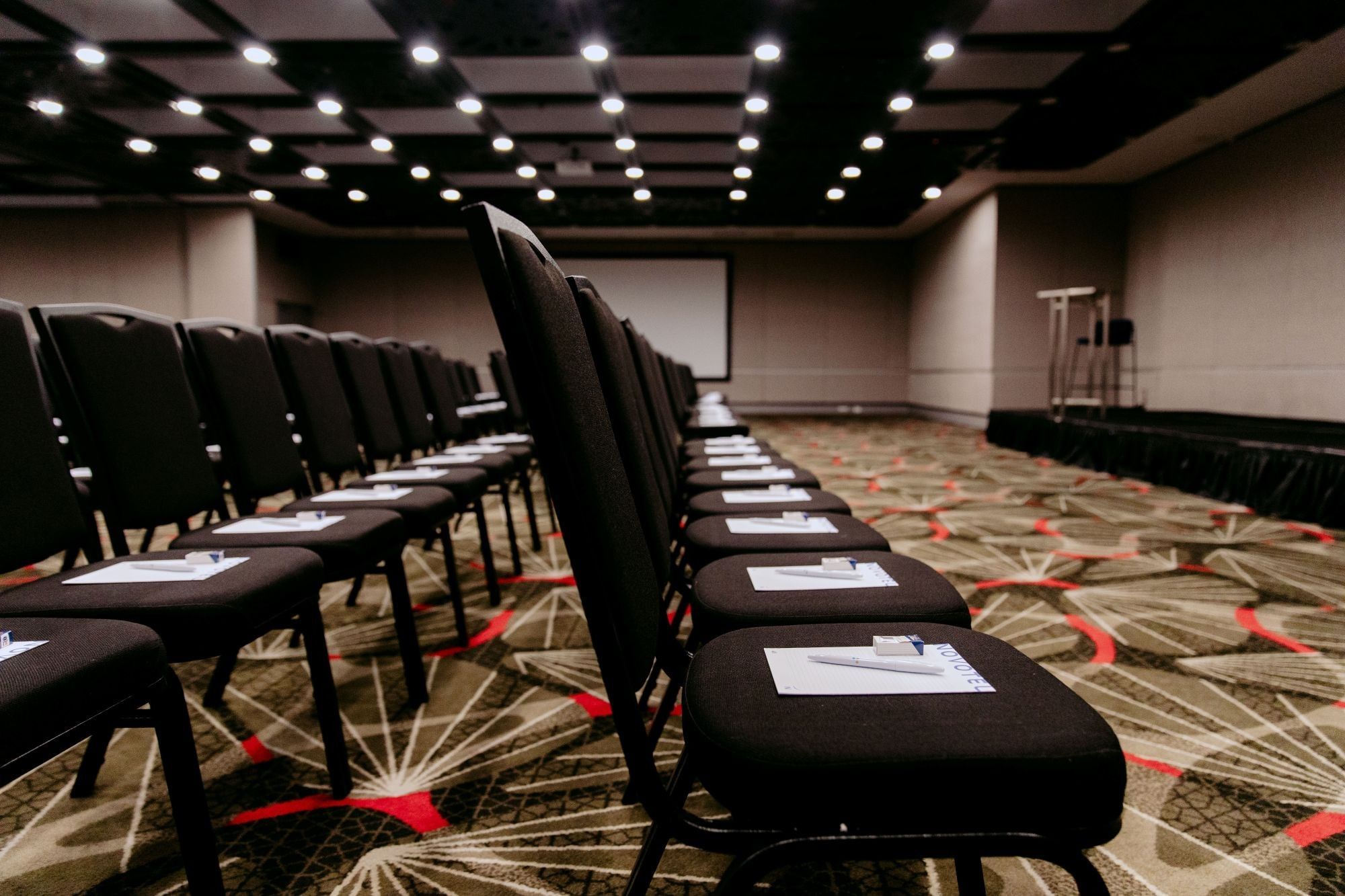 Chairs lined up in an empty conference room at Novotel Sydney Parramatta