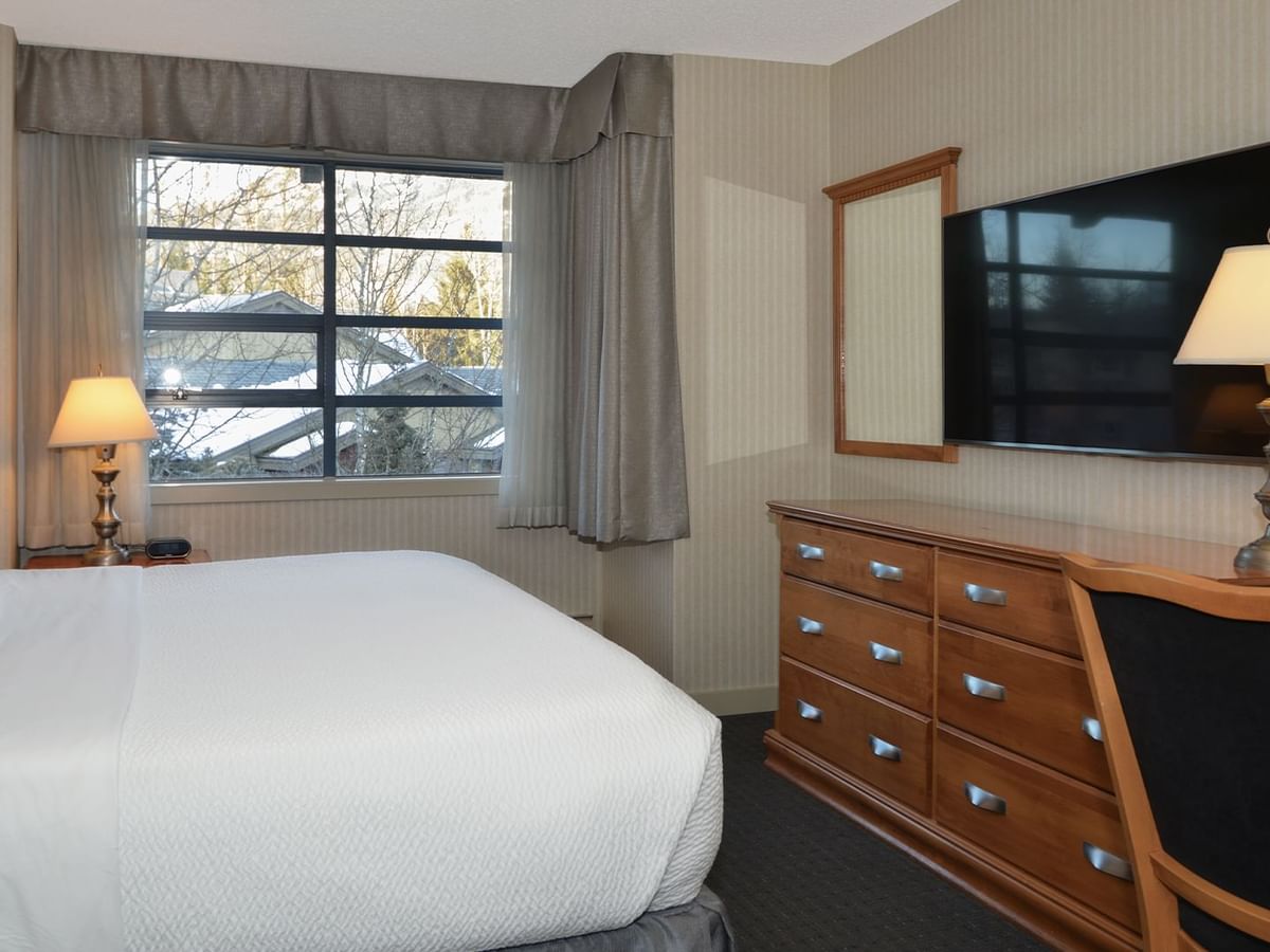 Hotel Junior Suite with king bed, HDTV and a large window.
