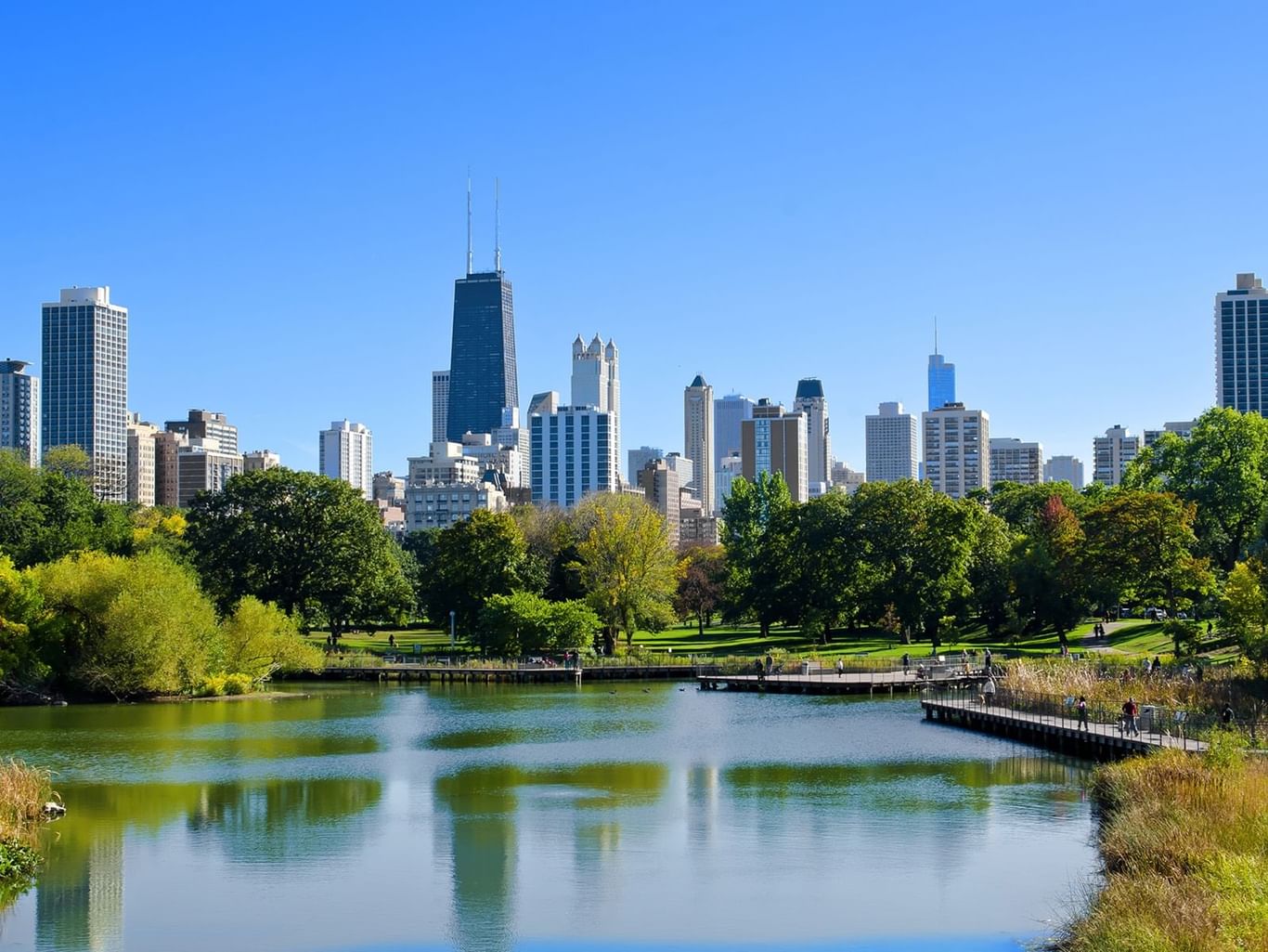 City skyline with tall buildings and park near Warwick Corporate
