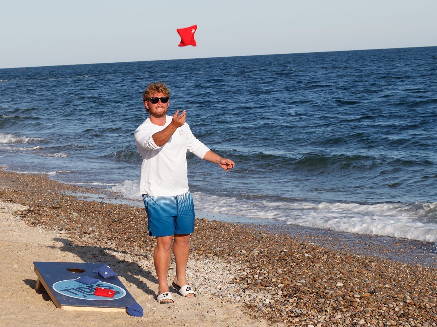 A guy playing games by the beach near Falmouth Tides