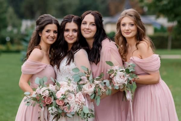 Bride with bridesmaids wearing affordable wedding attire, a great way to save money on a wedding