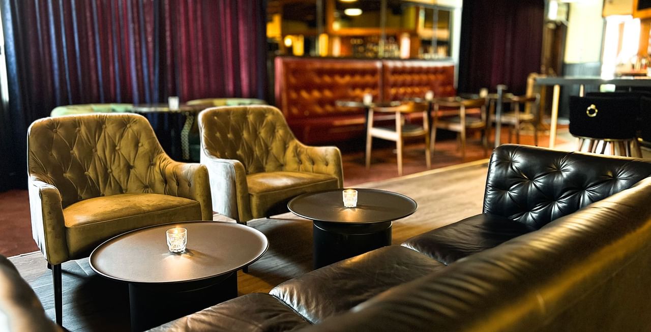 Sofas & chairs arranged by the bar counter in the lounge area at Midnight Sun, a Coast Hotel