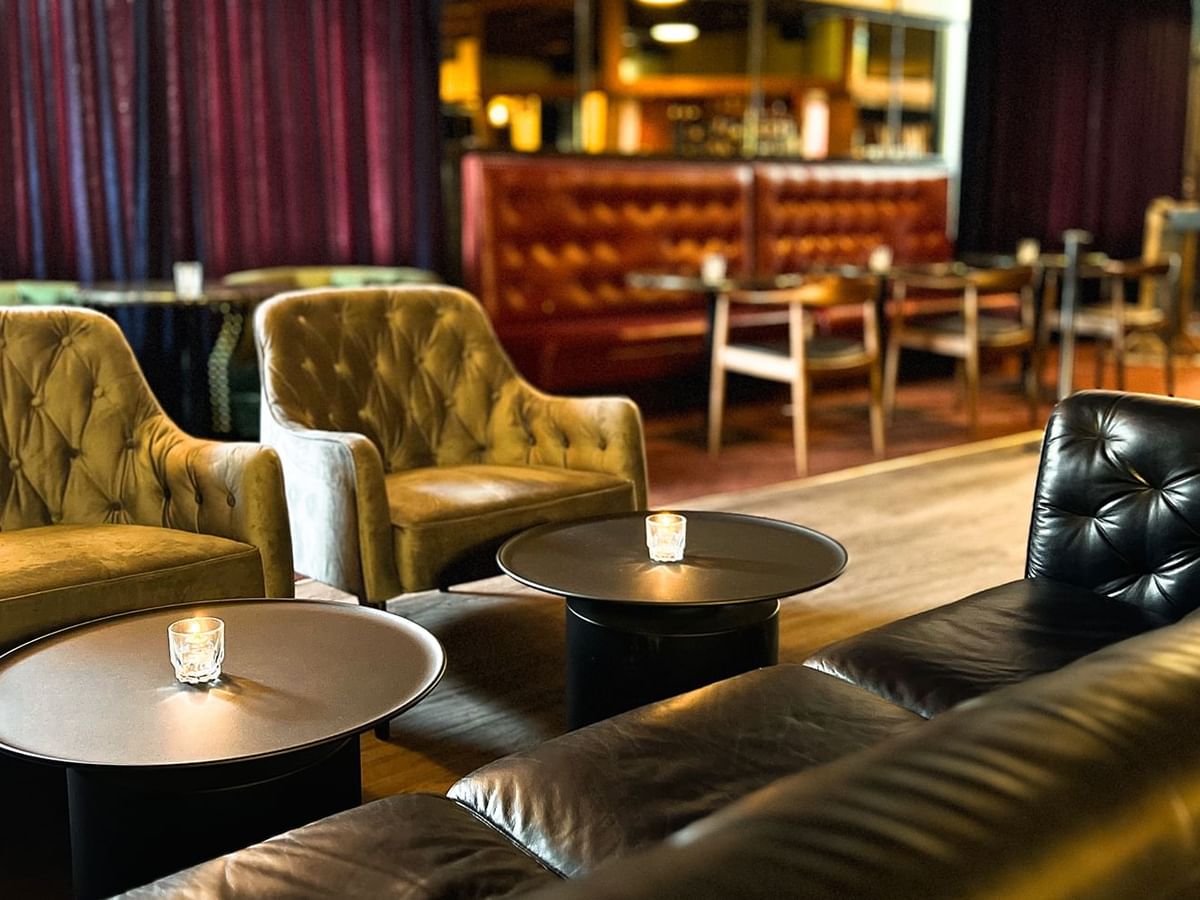 Sofas & chairs arranged by the bar counter in the lounge area at Midnight Sun, a Coast Hotel