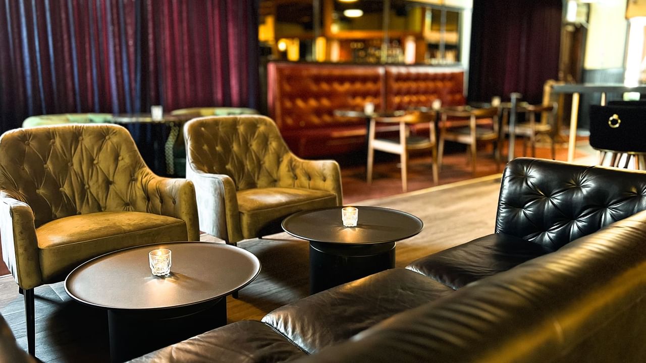 Sofas & chairs arranged by the bar counter in the lounge area at Midnight Sun, a Coast Hotel