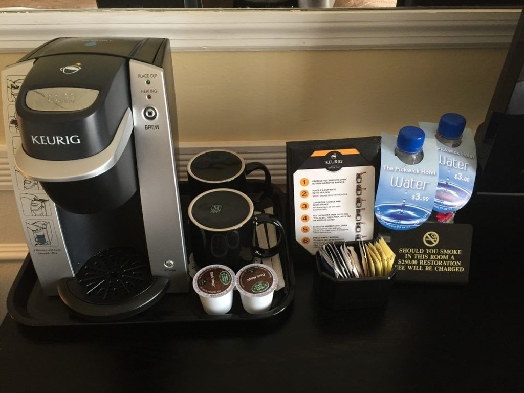 Coffee maker, water bottles, and instructions on black tray at Pickwick San Francisco.