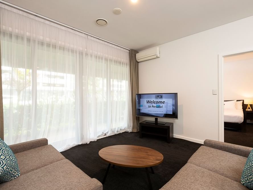 Lounge area with TV in One Bedroom Apartment at Nesuto Stadium