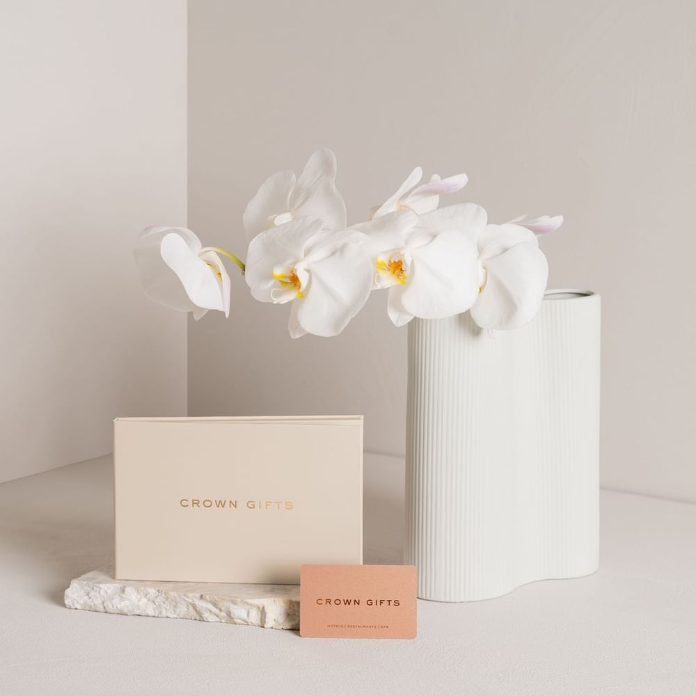 Orchids in a vase with elegant packaging boxes on a neutral background at Crown Towers Sydney