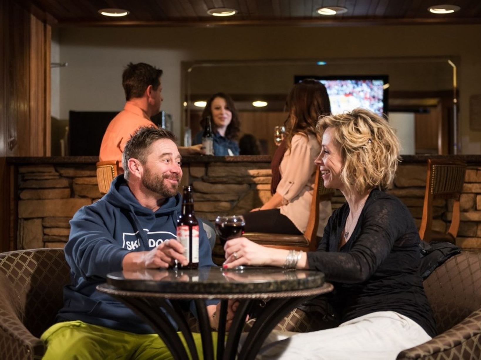 Couple enjoying drinks in Lobby Bar at MCM Elegante Lodge