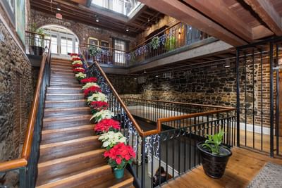 Staircase featuring floral arrangements & decorations at River Street Inn