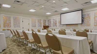 rows of tables and chairs in a meeting space