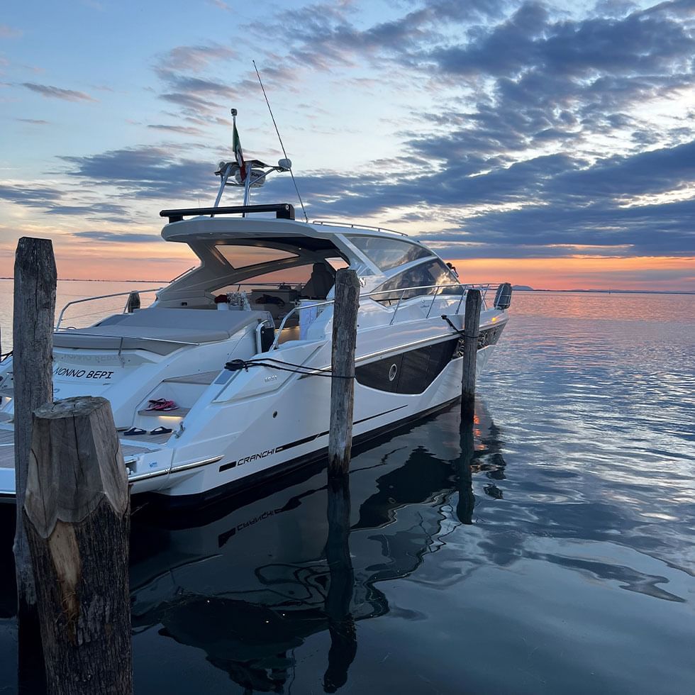 A Motor Yacht by the deck near Falkensteiner Hotels