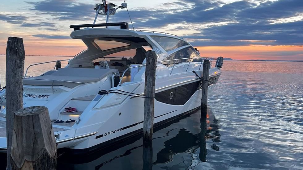 A Motor Yacht by the deck near Falkensteiner Hotels