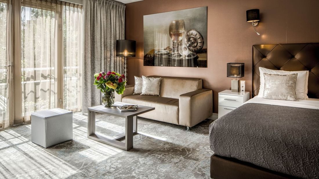 Comfy bed with lounge area in Luxury Suites at Luxury Suites Amsterdam
