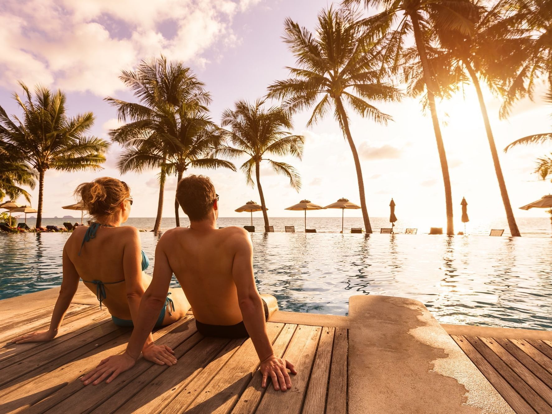 Couple watching sunset from pool deck at Daydream Island Resort