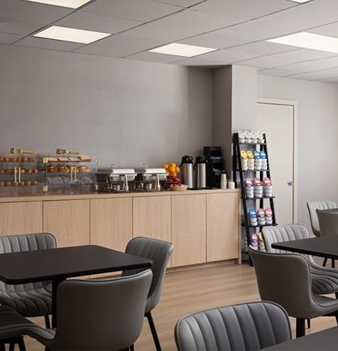 Complimentary hotel breakfast area with a buffet counter, and dining tables at The Harrison Hotel Downtown Hollywood