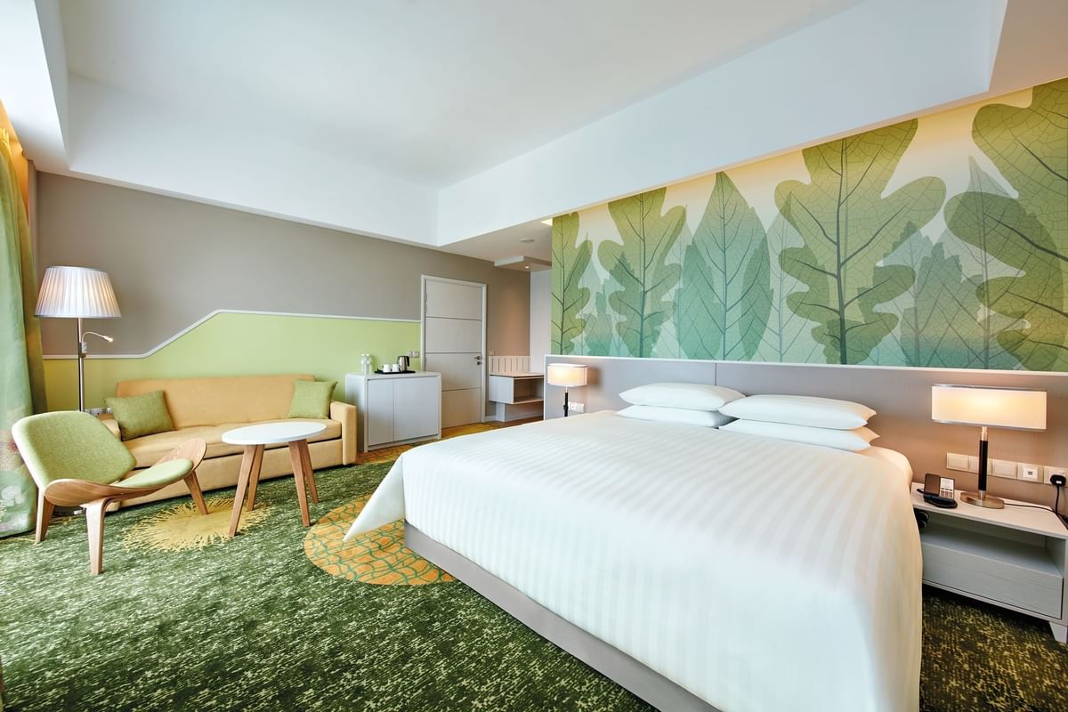 King-size bed with sitting area in a room at Sunway Velocity Hotel