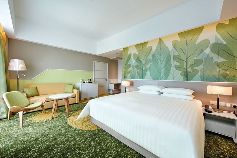 King-size bed with sitting area in a room at Sunway Velocity Hotel