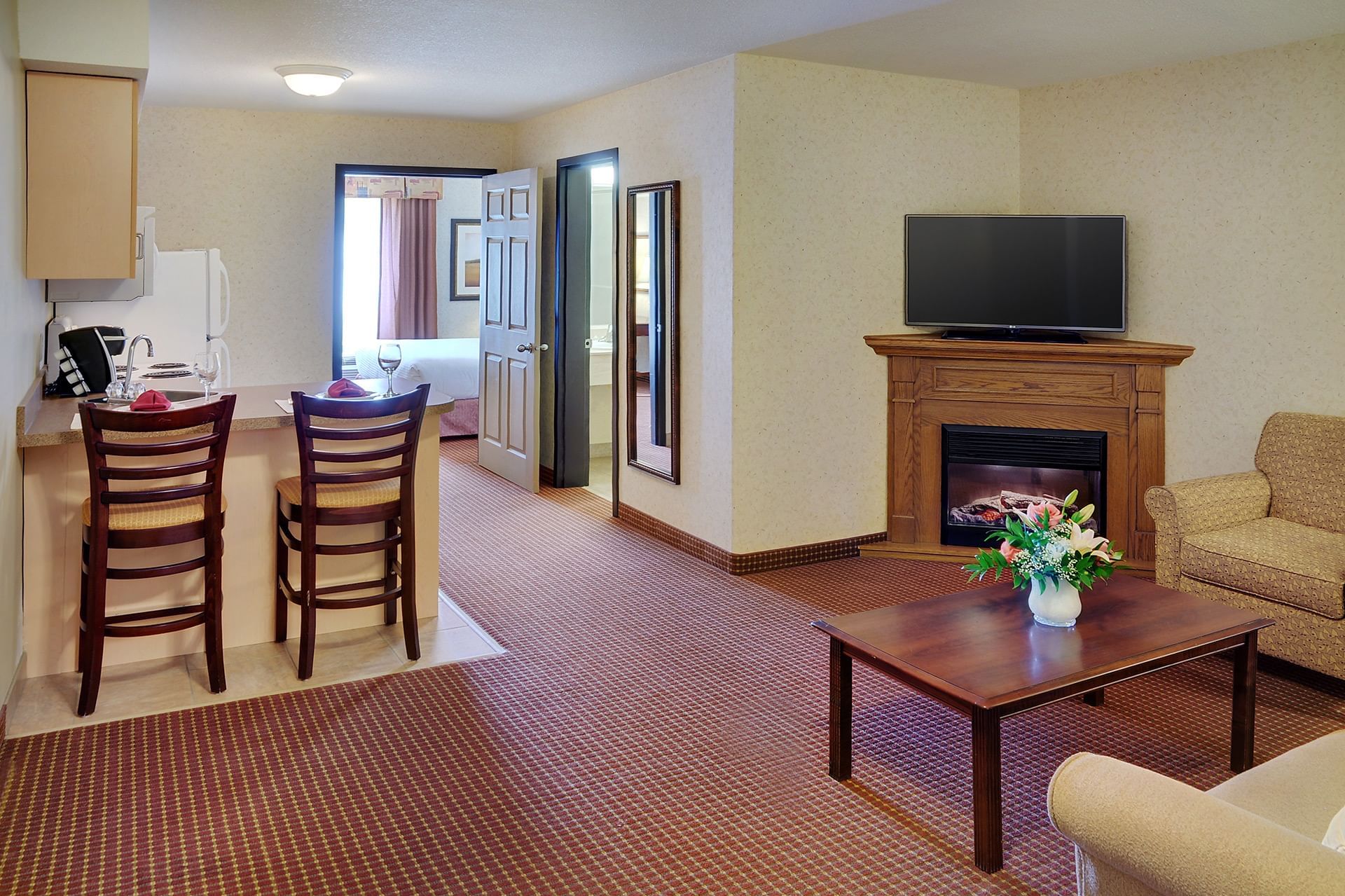 Grimshaw Hotel living room with fireplace and kitchen