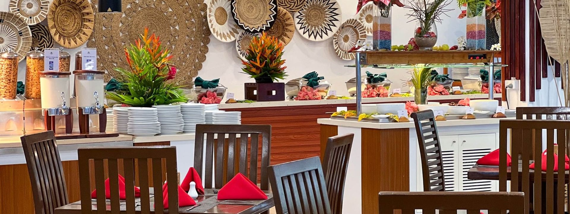 Nukunuku Restaurant & Bar dining area with wooden tables and chairs at The Naviti Resort in Korolevu.