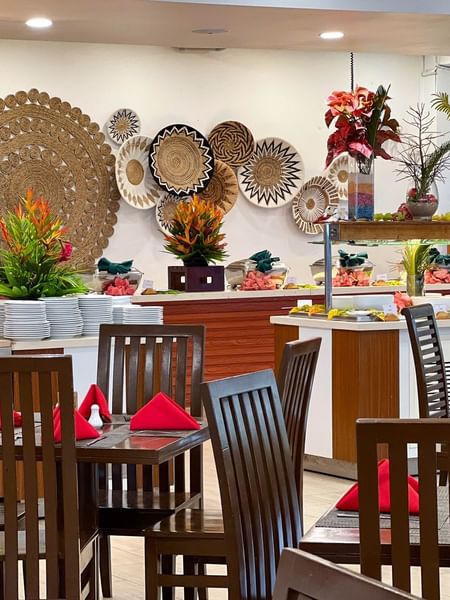 Nukunuku Restaurant & Bar dining area with wooden tables and chairs at The Naviti Resort in Korolevu.