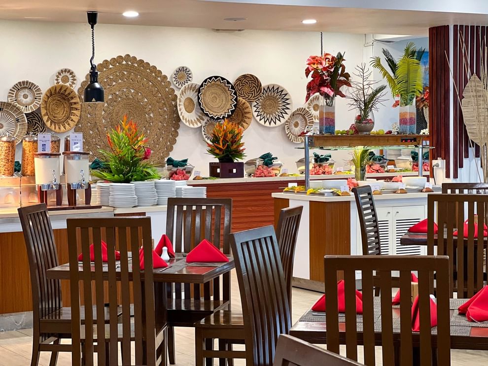 Nukunuku Restaurant & Bar dining area with wooden tables and chairs at The Naviti Resort in Korolevu.
