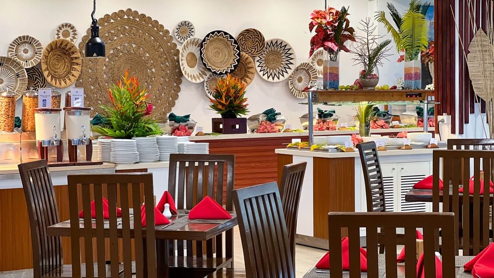 Nukunuku Restaurant & Bar dining area with wooden tables and chairs at The Naviti Resort in Korolevu.