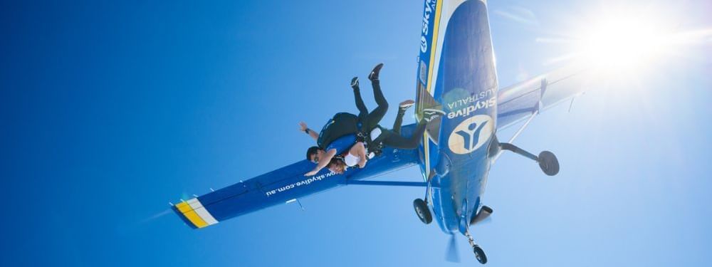 Couple jumping off a plane, featuring the Sky Dive Noosa near Novotel Sunshine Coast Resort
