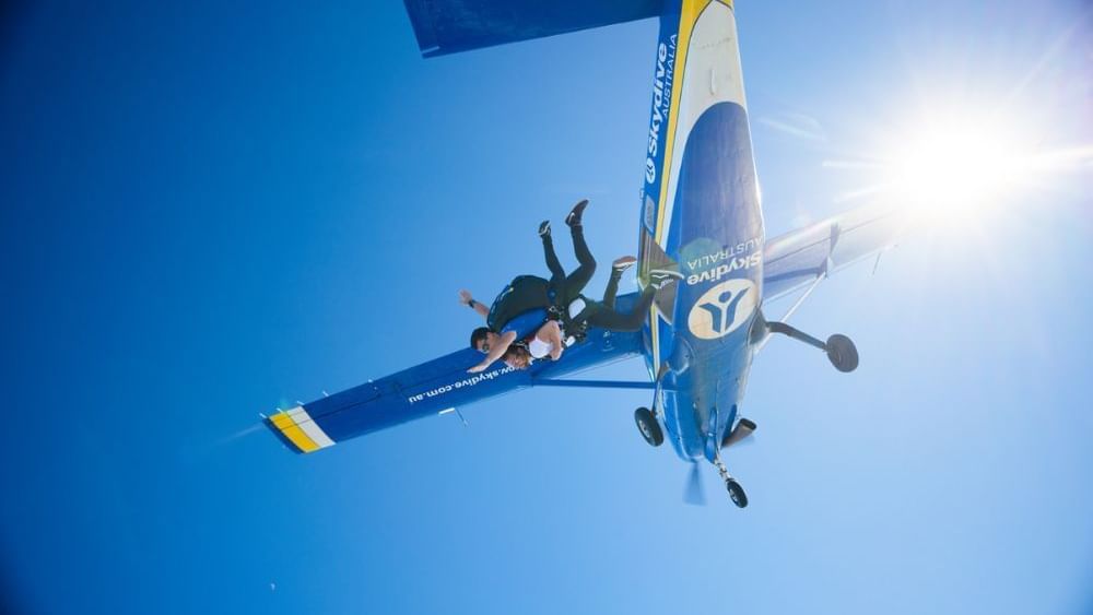 Couple jumping off a plane, featuring the Sky Dive Noosa near Novotel Sunshine Coast Resort