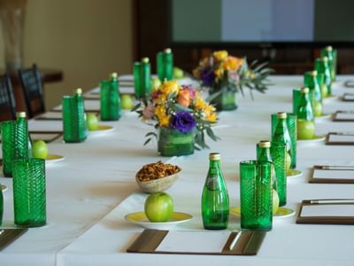 Meeting table set-up with bottles & vases at Cala de Mar