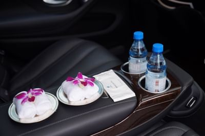 Towels, bottles placed on a car seat at Hanoi Daewoo Hotel