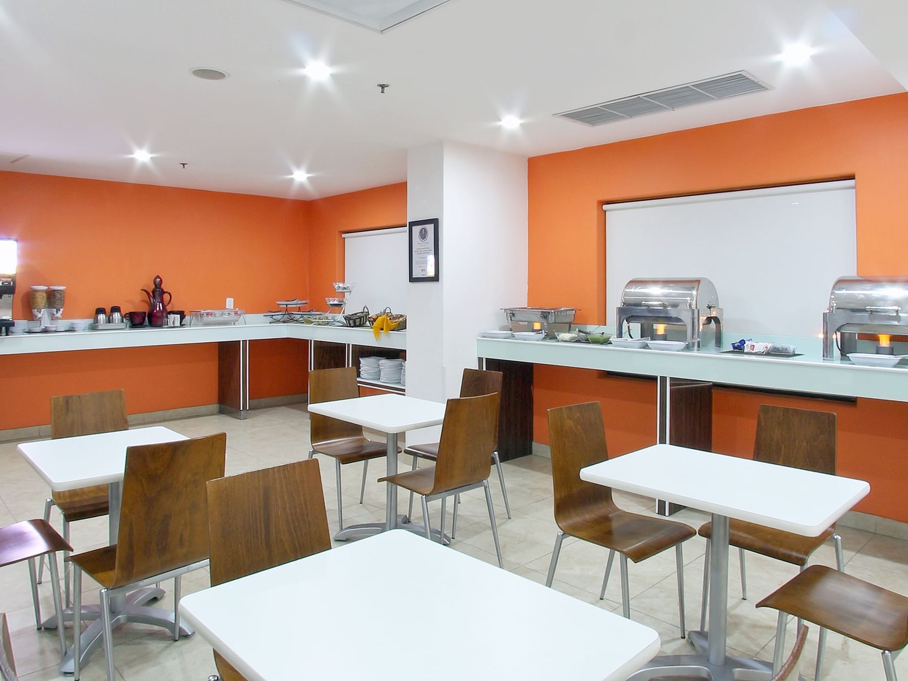 Dining tables arranged with buffet in Free Breakfast at One Hotels